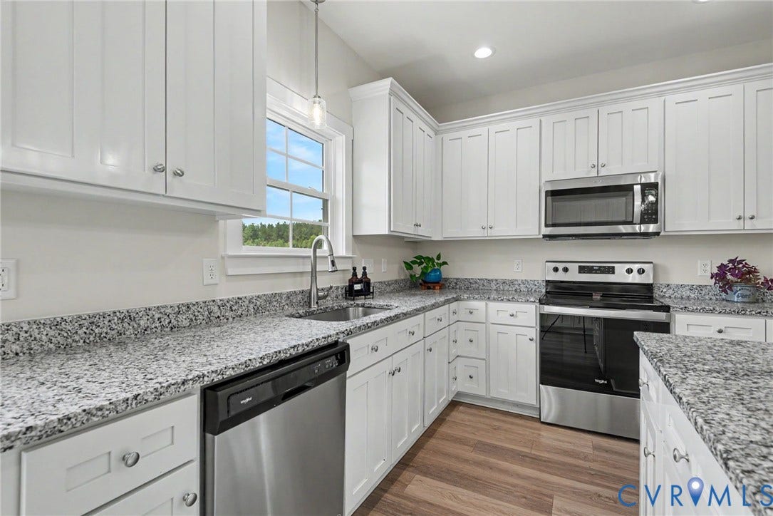 815 Kennon Road, Northeast Creek Reservoir Subd, Mineral, VA 23117 Kitchen featuring white shaker-style cabinetry, granite countertops, stainless steel appliances, wood-finish flooring, and recessed lighting