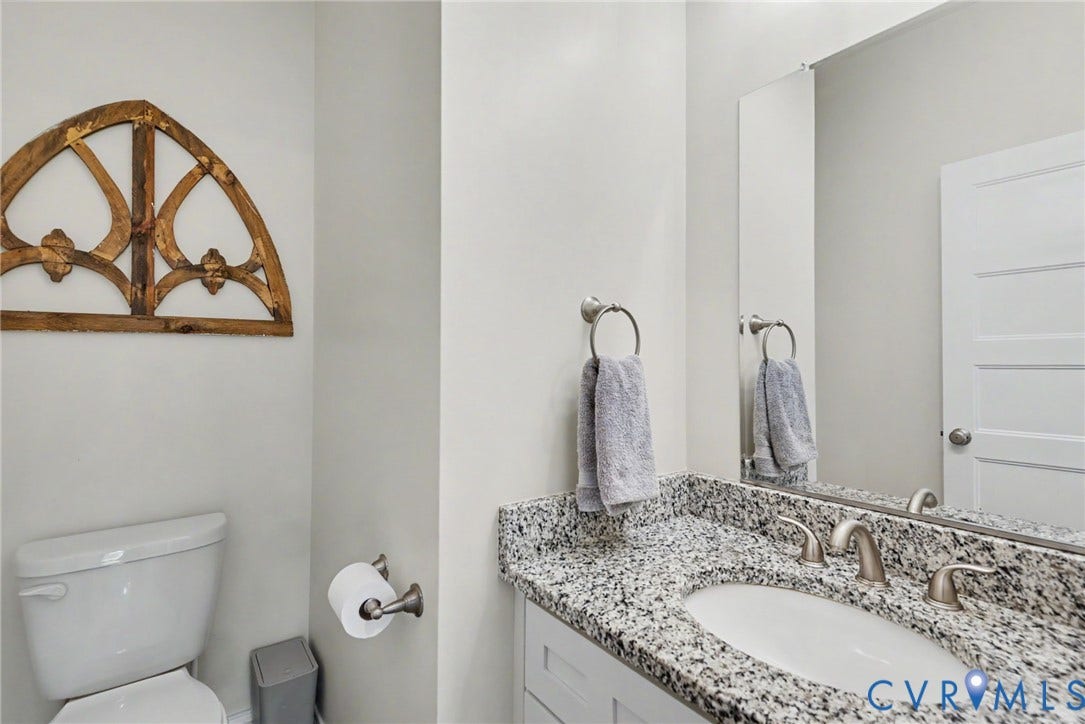 815 Kennon Road, Northeast Creek Reservoir Subd, Mineral, VA 23117 Bathroom vanity featuring a speckled countertop, undermount sink, and brushed nickel fixtures