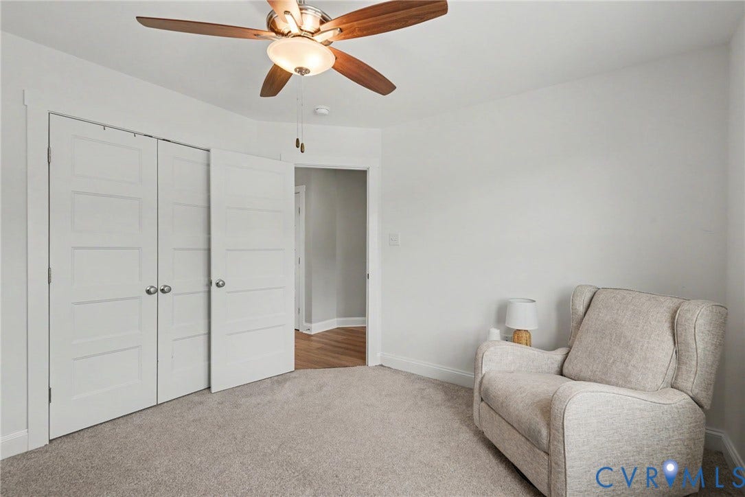 815 Kennon Road, Northeast Creek Reservoir Subd, Mineral, VA 23117 Carpeted room featuring a wood-finish ceiling fan with integrated lighting, white paneled bifold closet doors, and light wall finishes