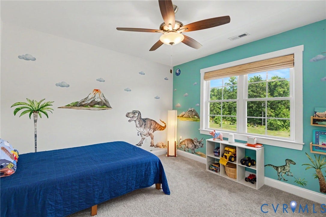 815 Kennon Road, Northeast Creek Reservoir Subd, Mineral, VA 23117 Bright room featuring a ceiling fan with integrated lighting, a large double-hung window with natural wood blinds, and light-colored carpeting