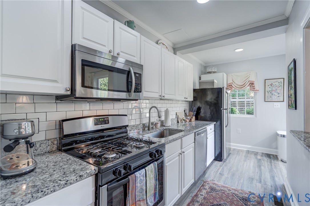 2619 Grayland Avenue, Byrd Park/Upper Fan, Richmond, VA 23220 Kitchen featuring white shaker-style cabinetry, stainless steel appliances, granite countertops, and subway tile backsplash