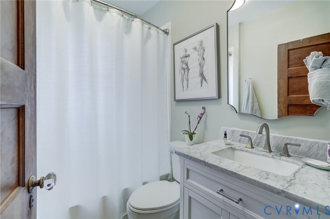 2619 Grayland Avenue, Byrd Park/Upper Fan, Richmond, VA 23220 Bathroom featuring a white vanity with paneling, marble countertop, and an undermount sink
