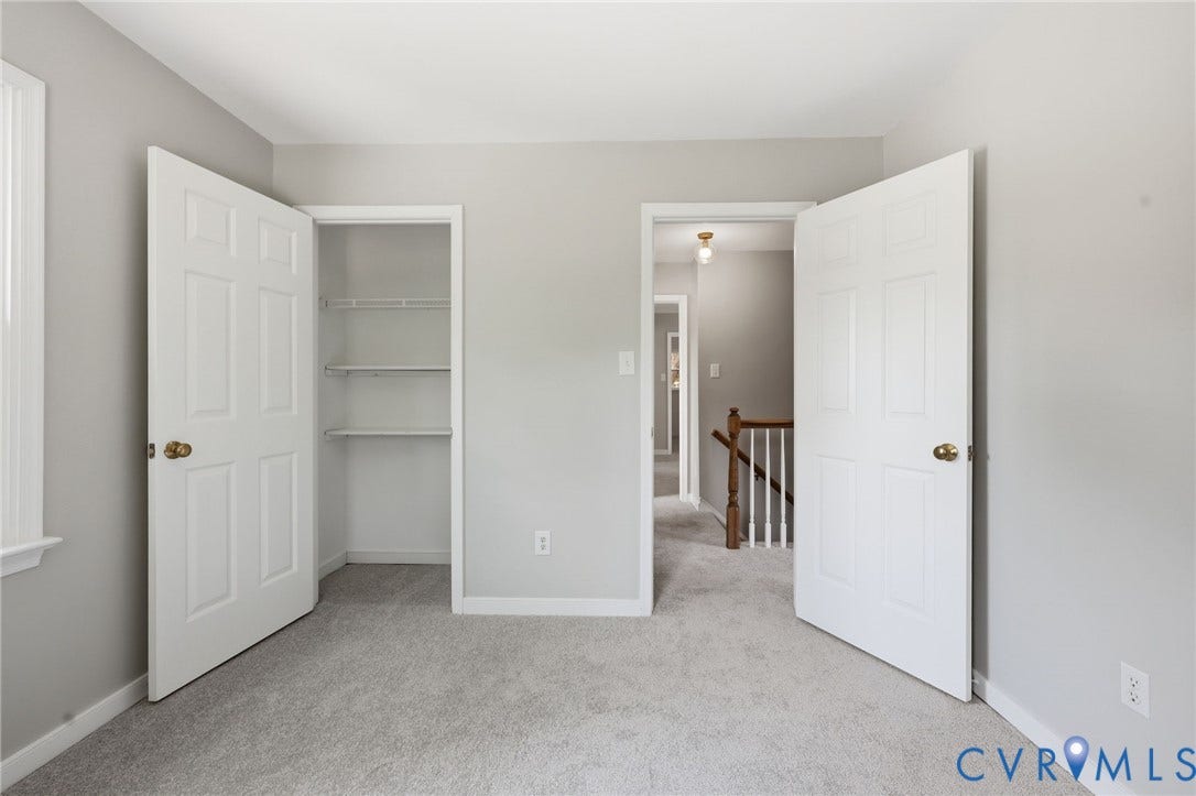 9500 Mesquite Road, Glen Allen, VA 23060 Carpeted room featuring a built-in closet with shelving and white paneled doors