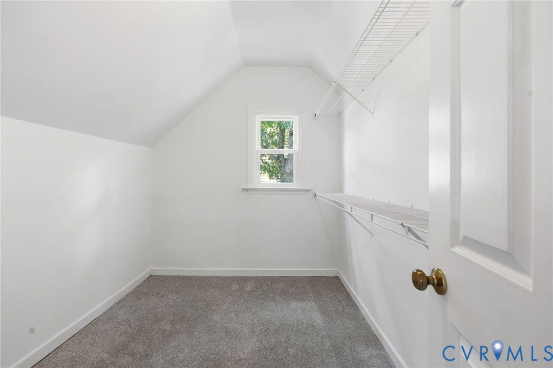 9500 Mesquite Road, Glen Allen, VA 23060 Attic room featuring a single window, sloped ceilings, wire shelving, and neutral carpeting