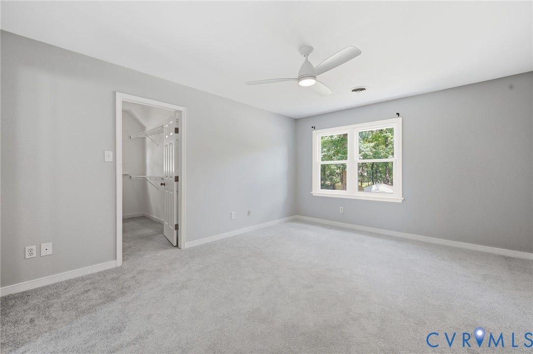 9500 Mesquite Road, Glen Allen, VA 23060 Spacious room with light gray carpeting, a multi-pane window, and a ceiling fan with integrated lighting