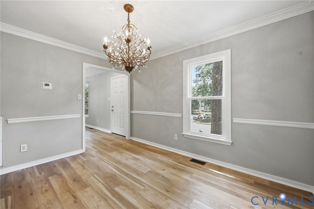9500 Mesquite Road, Glen Allen, VA 23060 Interior space featuring wood-finish flooring, light gray walls with chair rail molding, and a decorative chandelier
