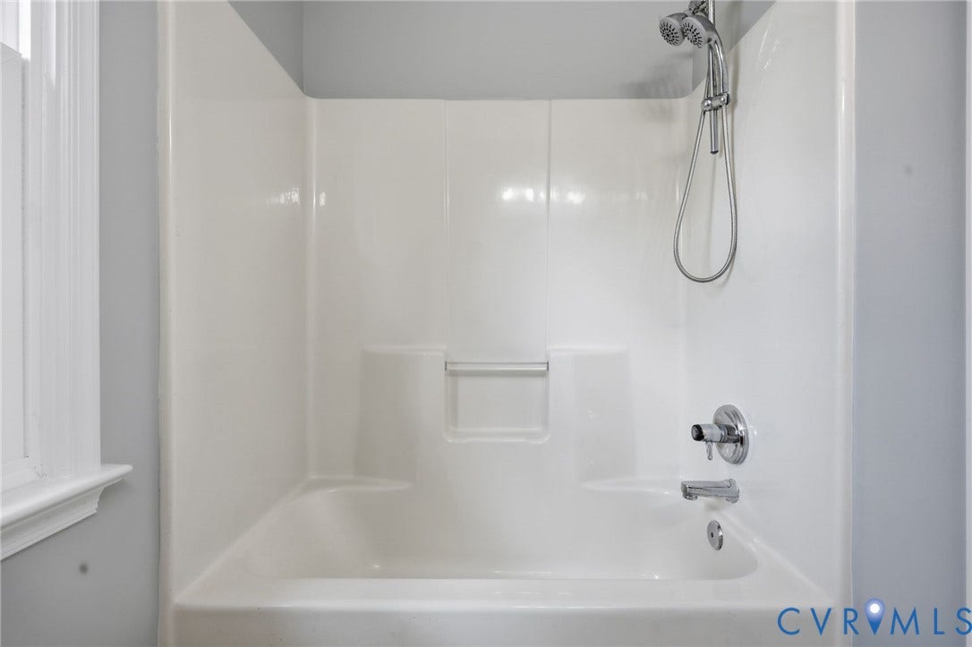 9500 Mesquite Road, Glen Allen, VA 23060 White fiberglass tub and shower combination with chrome fixtures, including a handheld showerhead