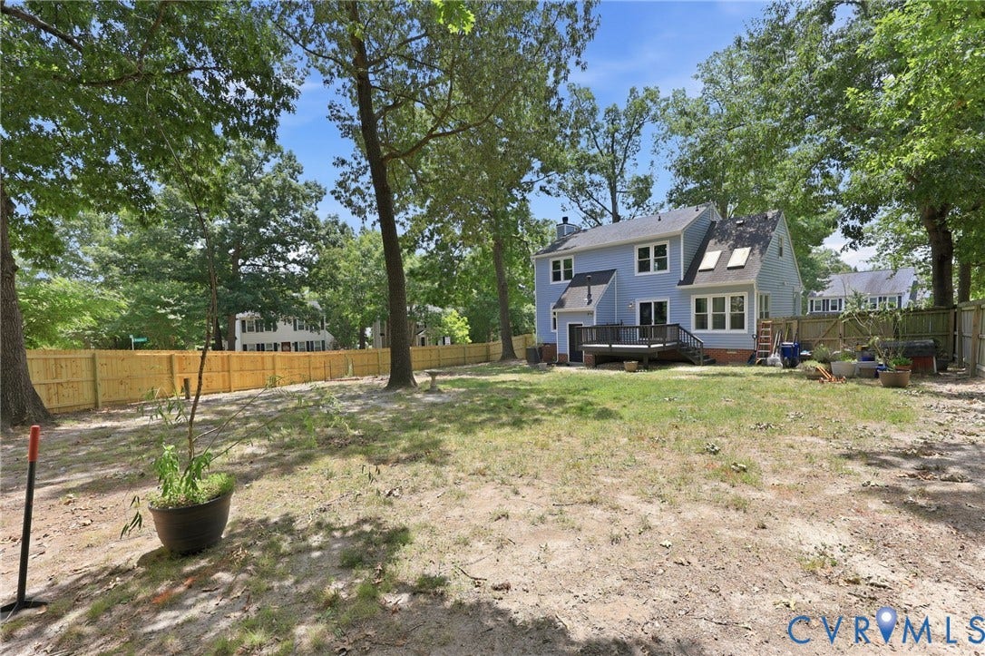 9500 Mesquite Road, Glen Allen, VA 23060 Spacious rear yard with a newly installed wood fence, mature trees, and a multi-level wood deck