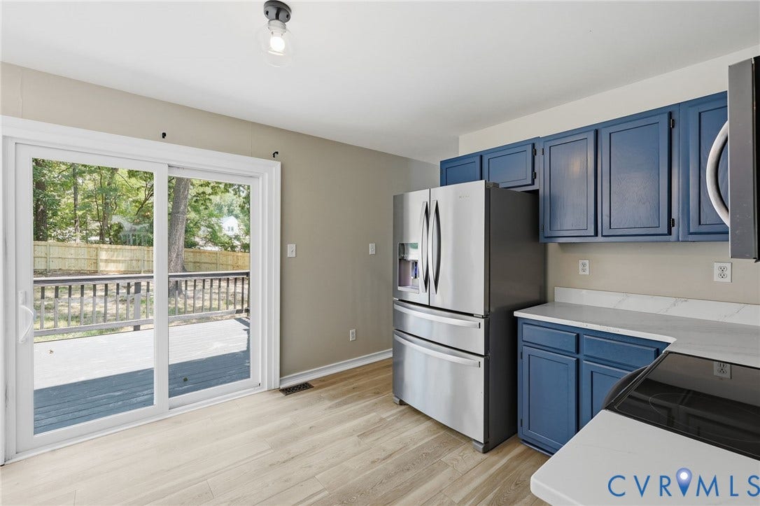 9500 Mesquite Road, Glen Allen, VA 23060 Kitchen featuring blue cabinetry, light-toned wood-finish flooring, and white countertops