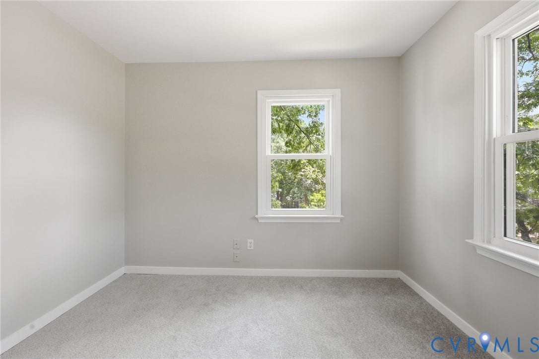 9500 Mesquite Road, Glen Allen, VA 23060 Room featuring light gray wall paint, white trim, two double-hung windows, and gray carpet flooring