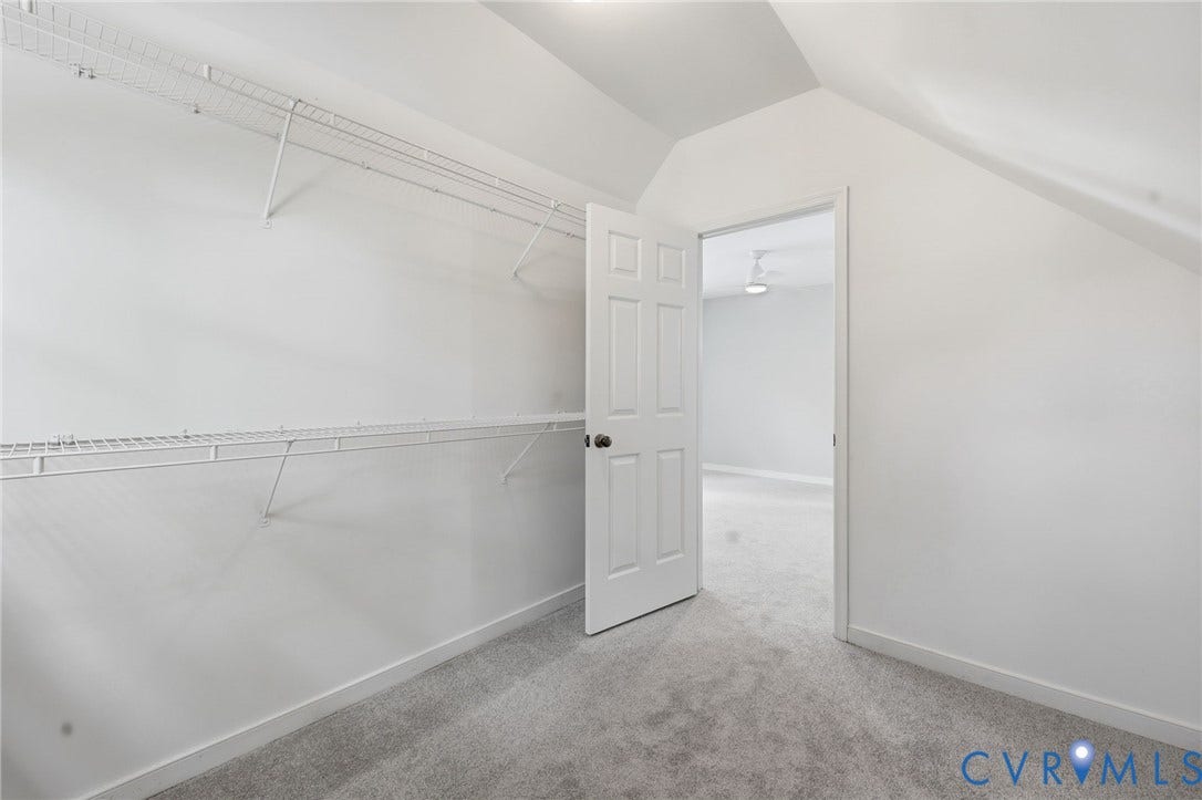 9500 Mesquite Road, Glen Allen, VA 23060 Closet area with sloped ceiling, wall-to-wall carpeting, white wire shelving, and a six-panel interior door