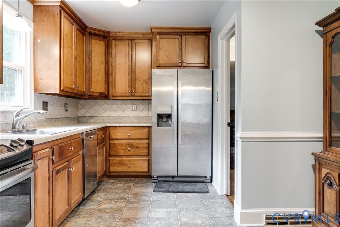 3924 Belspring Road, Chester, VA 23831 Kitchen featuring wood cabinetry, stainless steel appliances, a tiled backsplash, and resilient flooring