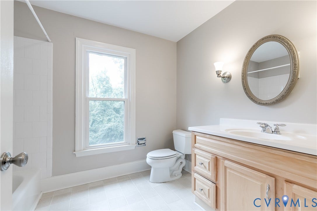 3924 Belspring Road, Chester, VA 23831 Full bathroom featuring a single window, a vanity with an integrated sink, an oval wall-mounted mirror, and a toilet