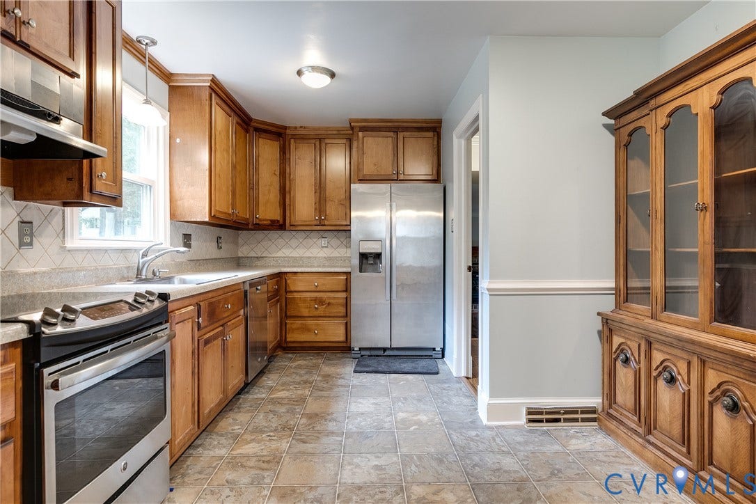 3924 Belspring Road, Chester, VA 23831 Kitchen featuring wood cabinetry, stainless steel appliances, a tile backsplash, and durable tile flooring