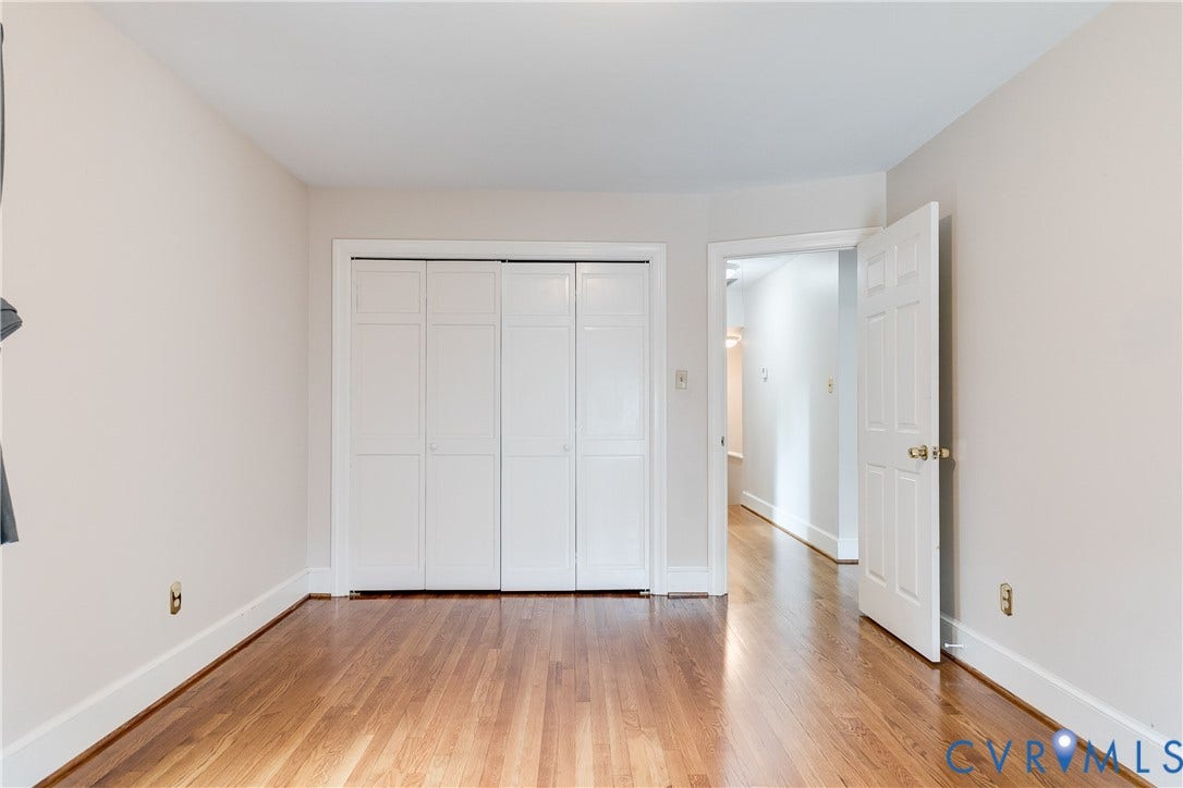 3924 Belspring Road, Chester, VA 23831 Hardwood flooring throughout, featuring a bi-fold closet with panel doors, white trim, and a neutral wall color
