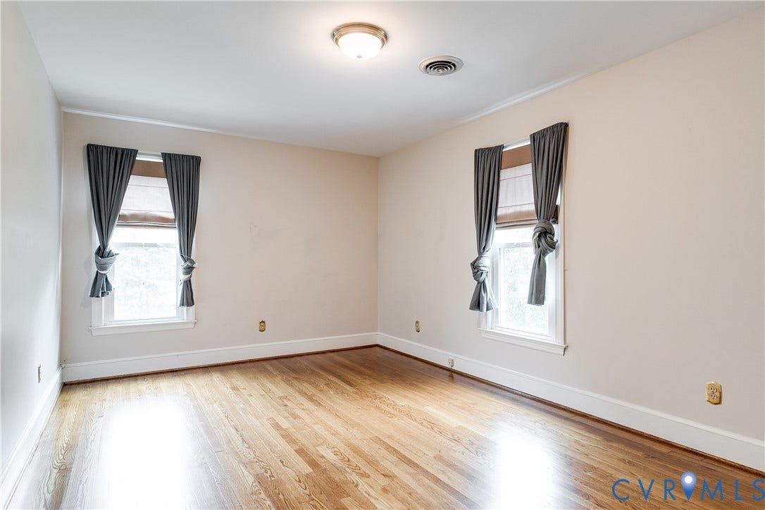 3924 Belspring Road, Chester, VA 23831 Bright interior room featuring wood-finish flooring, two windows with white trim, and light neutral wall finishes