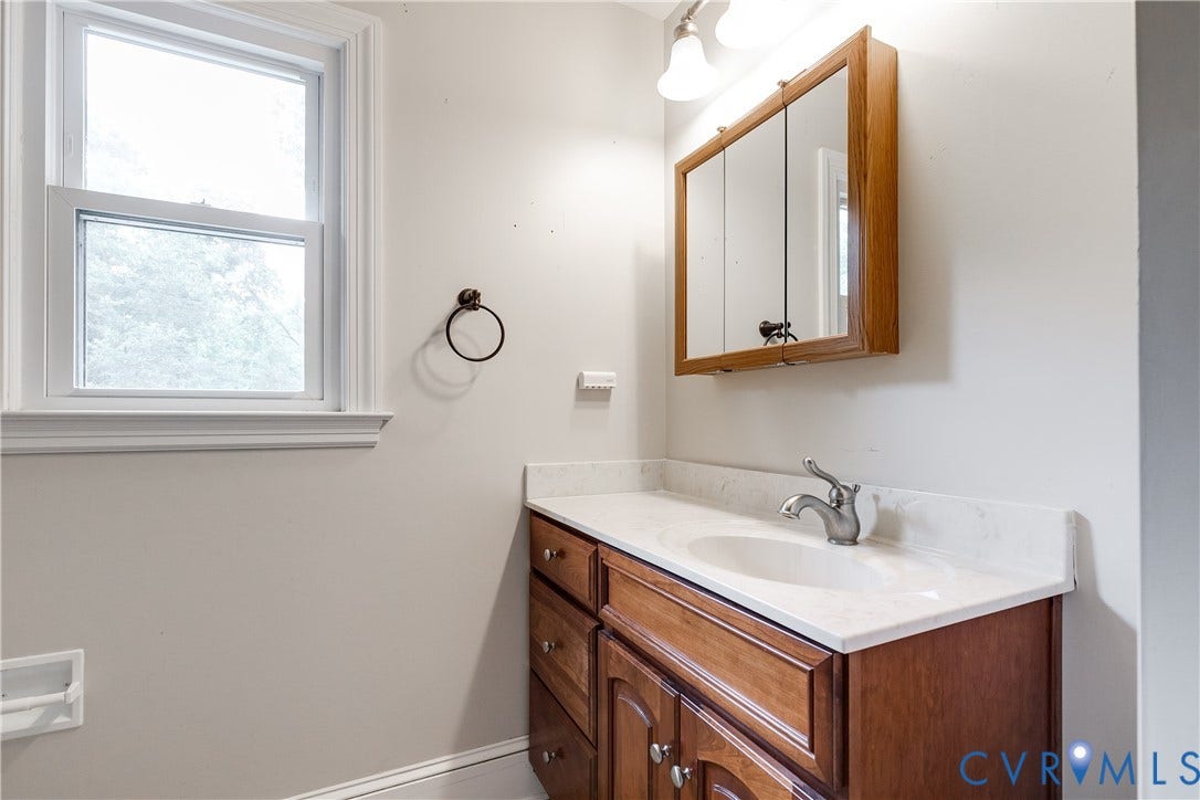 3924 Belspring Road, Chester, VA 23831 Bathroom featuring a wood-finish vanity with an integrated sink and light-colored countertop