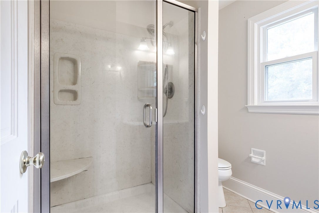 3924 Belspring Road, Chester, VA 23831 Glass-enclosed shower with a built-in bench and recessed shelving