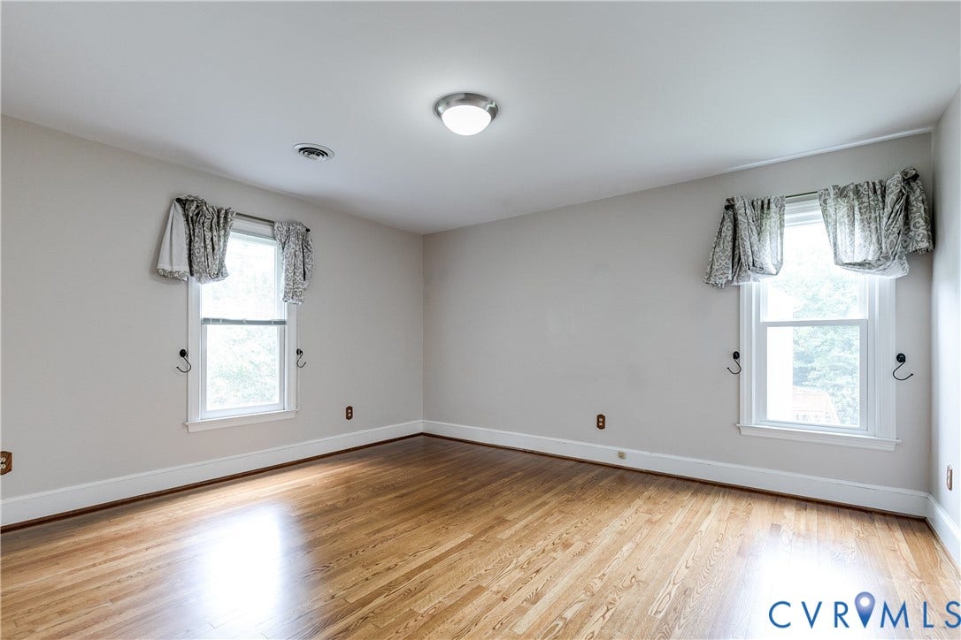 3924 Belspring Road, Chester, VA 23831 Bright interior space featuring wood-finish flooring, light-toned wall paint, and white trim