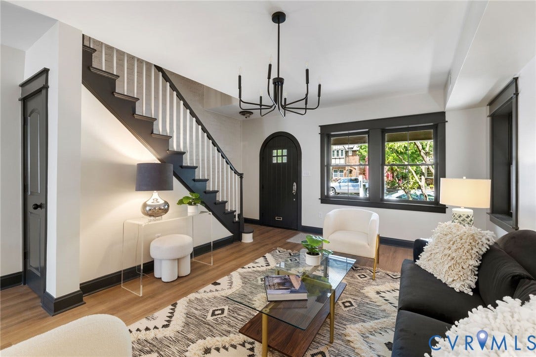 2627 Kensington Avenue, Museum District, Richmond, VA 23220 Foyer and living area featuring dark wood-finish flooring, a dark trim staircase with white risers, and an arched entry door with glass paneling