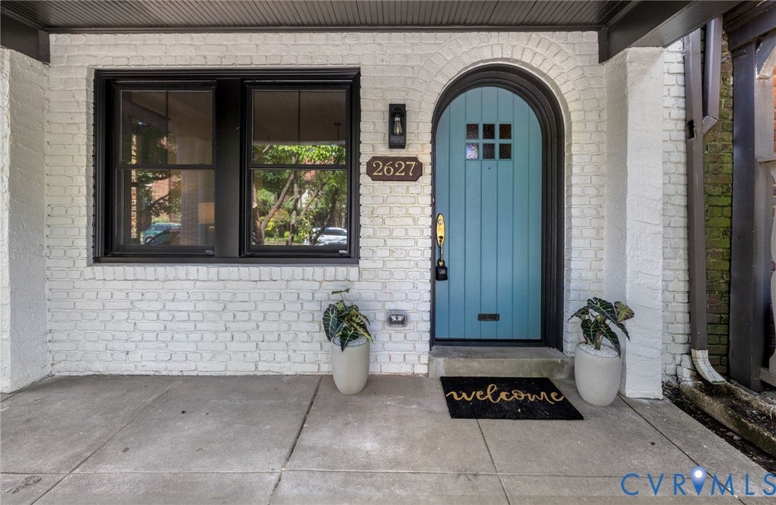 2627 Kensington Avenue, Museum District, Richmond, VA 23220 Arched entry featuring a teal-paneled door with dark trim, contrasting with the white painted brick facade