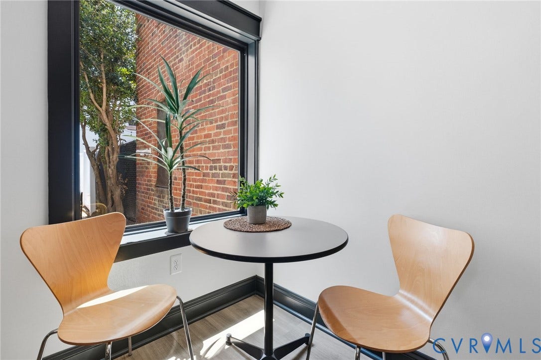 2627 Kensington Avenue, Museum District, Richmond, VA 23220 Large picture window with black trim, wood-finish flooring, and white walls