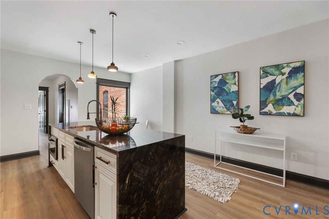 2627 Kensington Avenue, Museum District, Richmond, VA 23220 Kitchen island featuring a dark stone countertop with integrated sink and modern faucet
