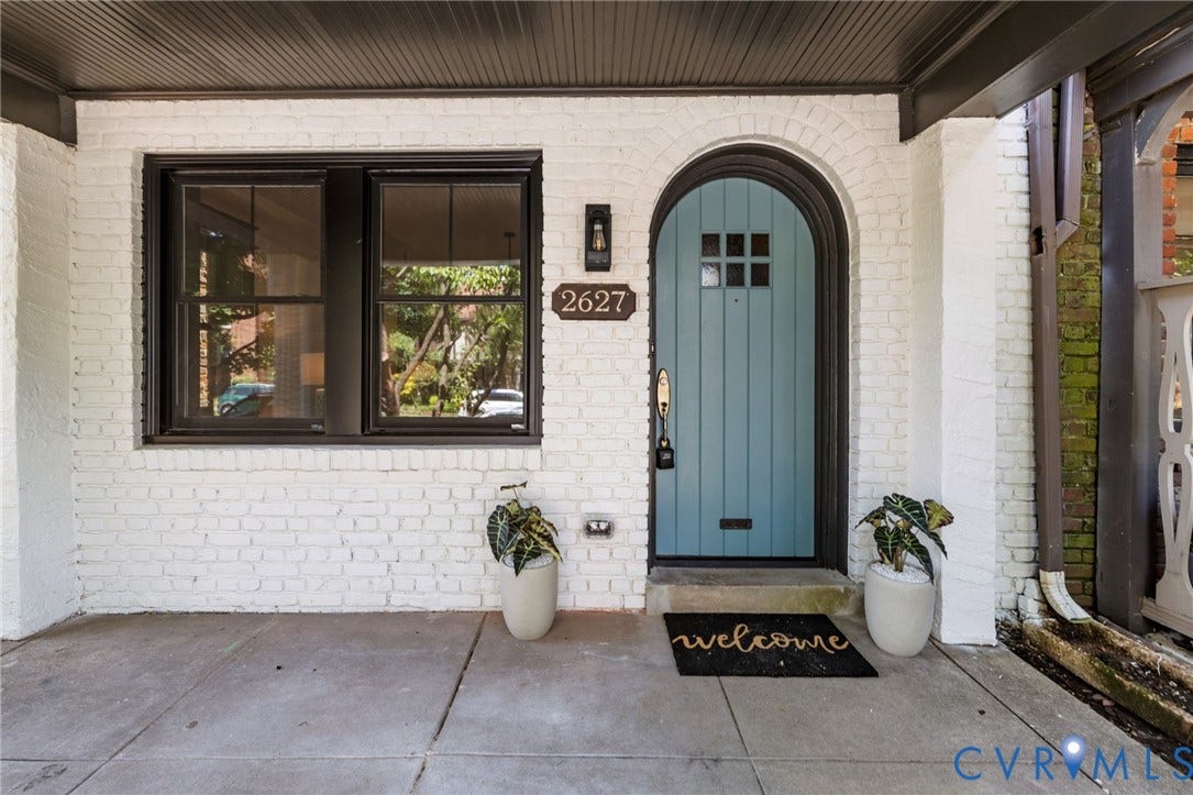 2627 Kensington Avenue, Museum District, Richmond, VA 23220 Brick exterior painted white featuring a distinctive arched entry door