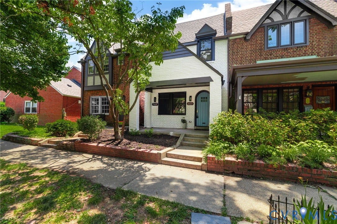 2627 Kensington Avenue, Museum District, Richmond, VA 23220 Tudor-style facade featuring a stucco and brick exterior, dark trim accents, multiple gables, and a prominent front entrance with a light blue door