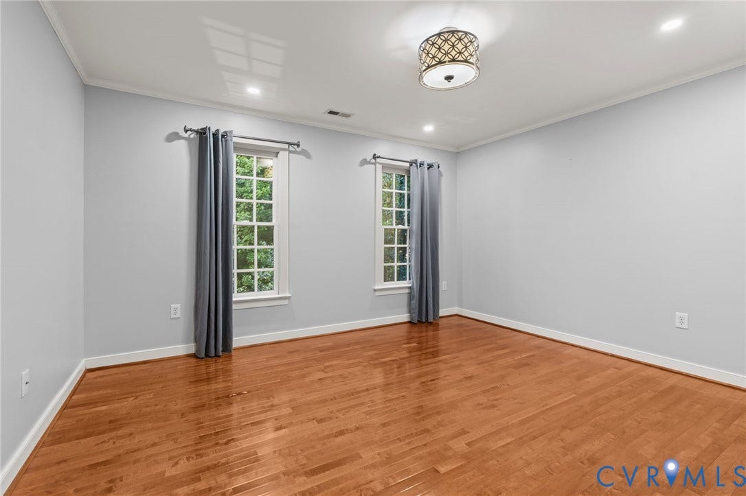 Hardwood flooring throughout, crown molding, and recessed lighting