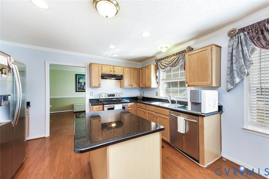 1900 Brilland Court, Glen Allen, VA 23060 Kitchen featuring wood-finish flooring, light-toned cabinetry, dark countertops, and a central island with a matching dark countertop