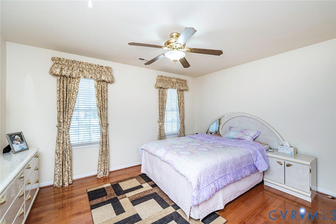 1900 Brilland Court, Glen Allen, VA 23060 Bedroom 2 Hardwood-style flooring extends throughout this room, complemented by two windows featuring blinds and patterned valances