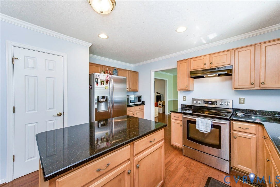 1900 Brilland Court, Glen Allen, VA 23060 Kitchen featuring a central island with a speckled dark countertop, stainless steel appliances, light wood-finish cabinetry, and recessed lighting