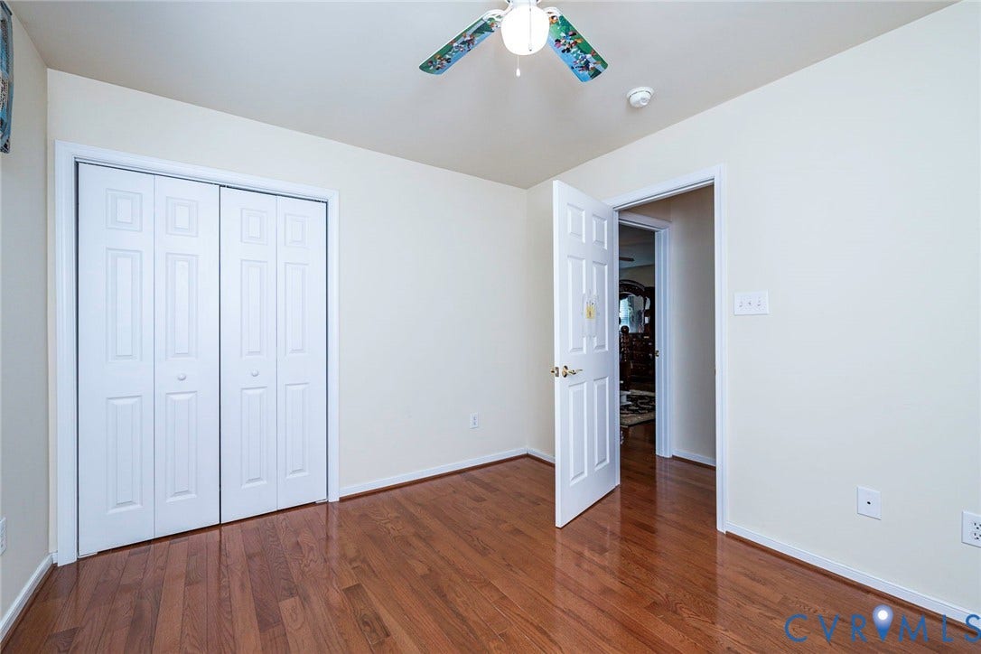 1900 Brilland Court, Glen Allen, VA 23060 Bedroom 4 Hardwood flooring throughout this room, featuring a bi-fold closet with white paneled doors, and a ceiling fan with integrated lighting