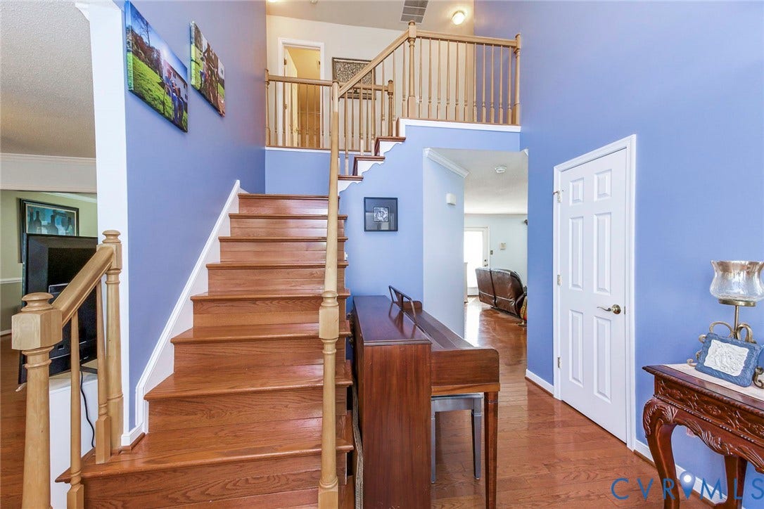 1900 Brilland Court, Glen Allen, VA 23060 Two-story foyer featuring hardwood flooring, a matching hardwood staircase with wood balusters, and a paneled interior door