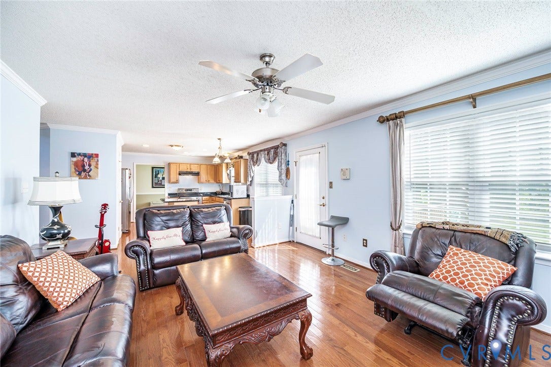 1900 Brilland Court, Glen Allen, VA 23060 Open-concept living area featuring wood-finish flooring, a ceiling fan with integrated lighting, and crown molding