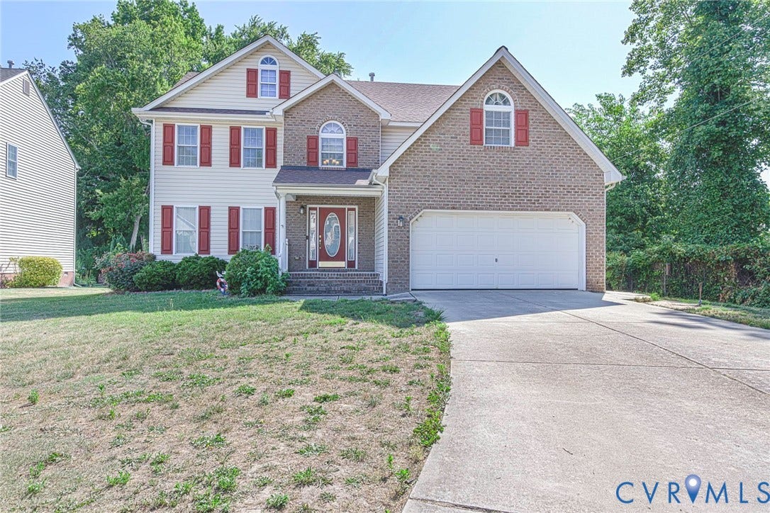 1900 Brilland Court, Glen Allen, VA 23060 Two-story traditional exterior featuring brick and siding, a covered entry with a decorative glass door, a two-car garage, red window shutters, and a concrete driveway
