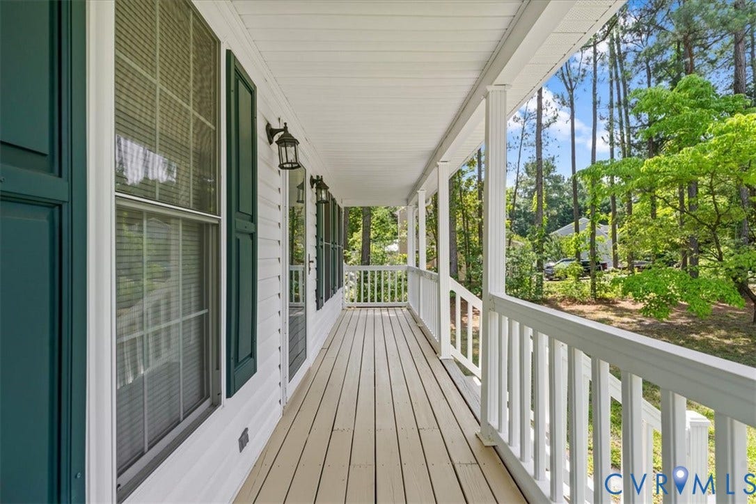 2924 Warfield Ridge Terrace, Chester, VA 23831 Expansive front porch featuring light-toned wood-finish flooring, white railing, white siding, and dark green louvered shutters