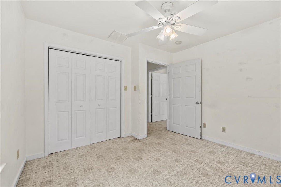 2924 Warfield Ridge Terrace, Chester, VA 23831 Interior room featuring neutral wall tones, patterned carpet flooring, a ceiling fan with integrated lighting, and white paneled doors