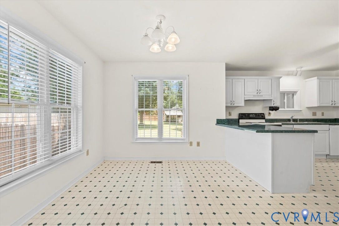 2924 Warfield Ridge Terrace, Chester, VA 23831 Kitchen and dining area featuring a white appliance suite, white cabinetry, green countertops, and patterned tile flooring