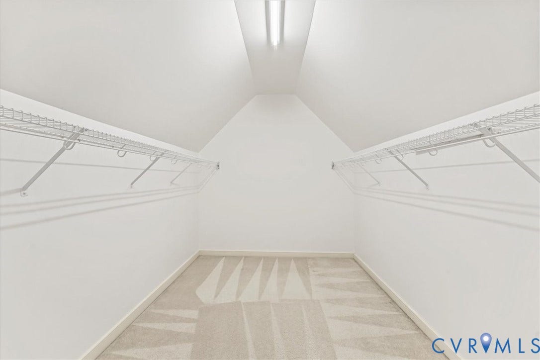 2924 Warfield Ridge Terrace, Chester, VA 23831 Closet space featuring sloped ceilings, white wire shelving, wall-mounted hanging rods, soft carpet flooring, and integrated ceiling lighting