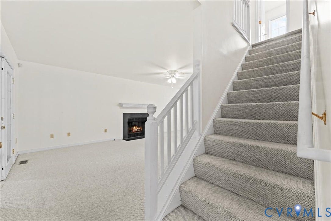 2924 Warfield Ridge Terrace, Chester, VA 23831 Carpeted staircase with white handrail and brass wall-mounted rail supports