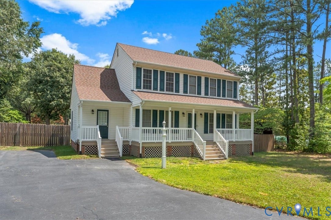 2924 Warfield Ridge Terrace, Chester, VA 23831 Two-story residence featuring white siding, a covered front porch with white railings, and dark green louvered shutters