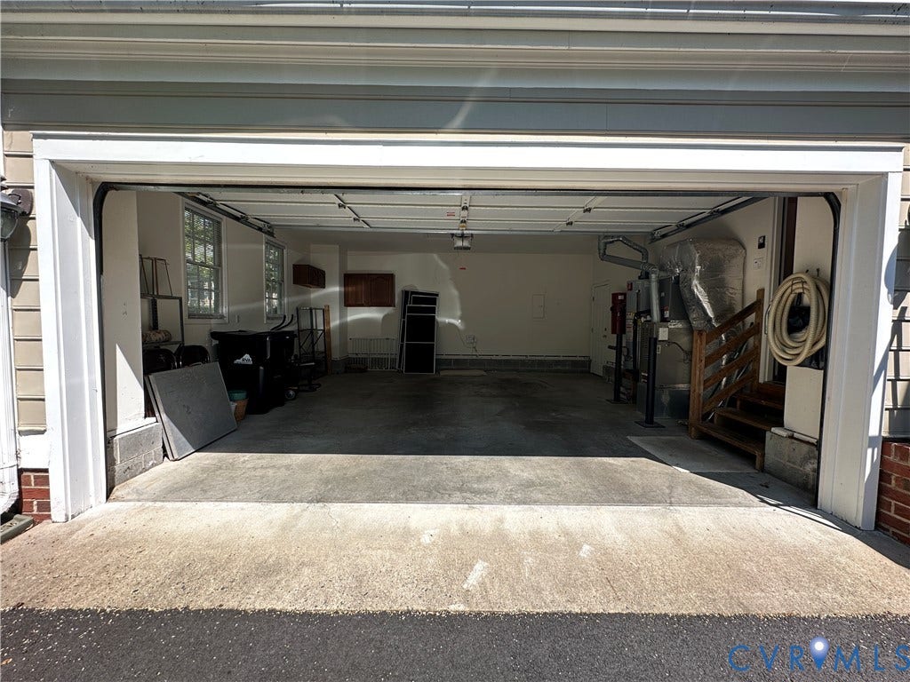 12112 Kershaw Place, Wyndham, Glen Allen, VA 23059 Attached two-car garage featuring a concrete floor, exposed ceiling joists, and two visible windows