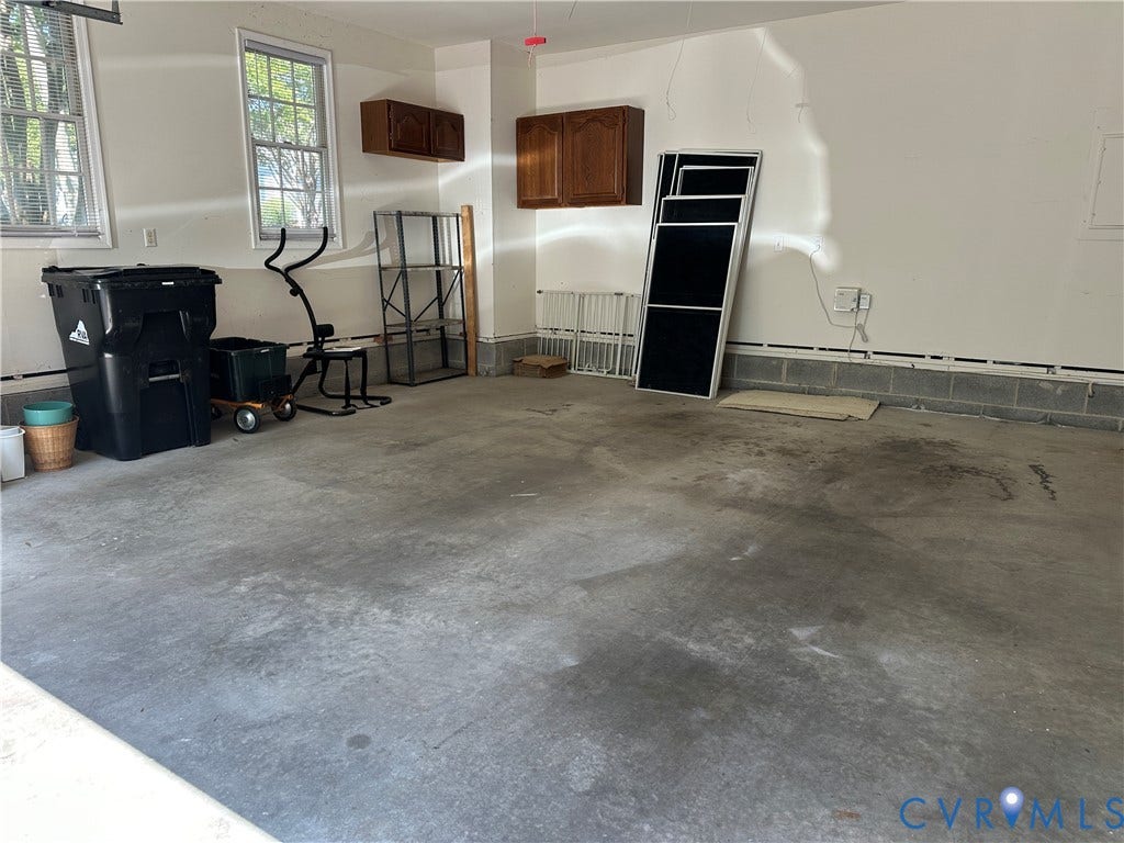 12112 Kershaw Place, Wyndham, Glen Allen, VA 23059 Concrete flooring with two windows, painted white walls, and wall-mounted cabinetry