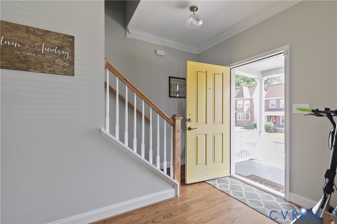 1301 Dance Street, Randolph, Richmond, VA 23220 Foyer featuring hardwood flooring, a yellow paneled front door, white baluster staircase, and crown molding