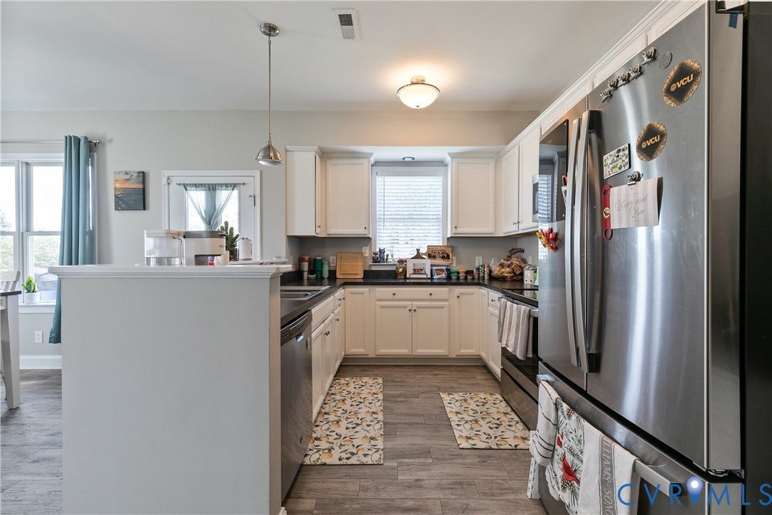 1301 Dance Street, Randolph, Richmond, VA 23220 Kitchen featuring white cabinetry, dark countertops, wood-finish flooring, stainless steel appliances, and a central island