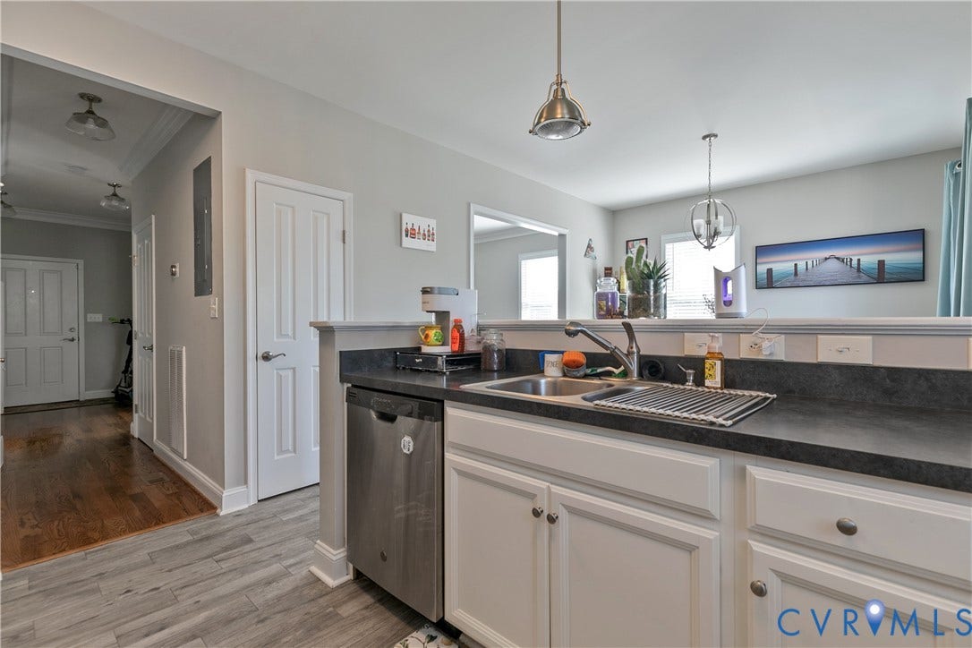 1301 Dance Street, Randolph, Richmond, VA 23220 Kitchen area featuring a stainless steel sink, white cabinetry with silver hardware, and a dark countertop