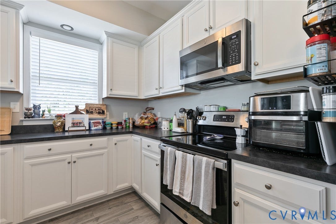 1301 Dance Street, Randolph, Richmond, VA 23220 Kitchen featuring white cabinetry, dark countertops, stainless steel appliances, and wood-finish flooring