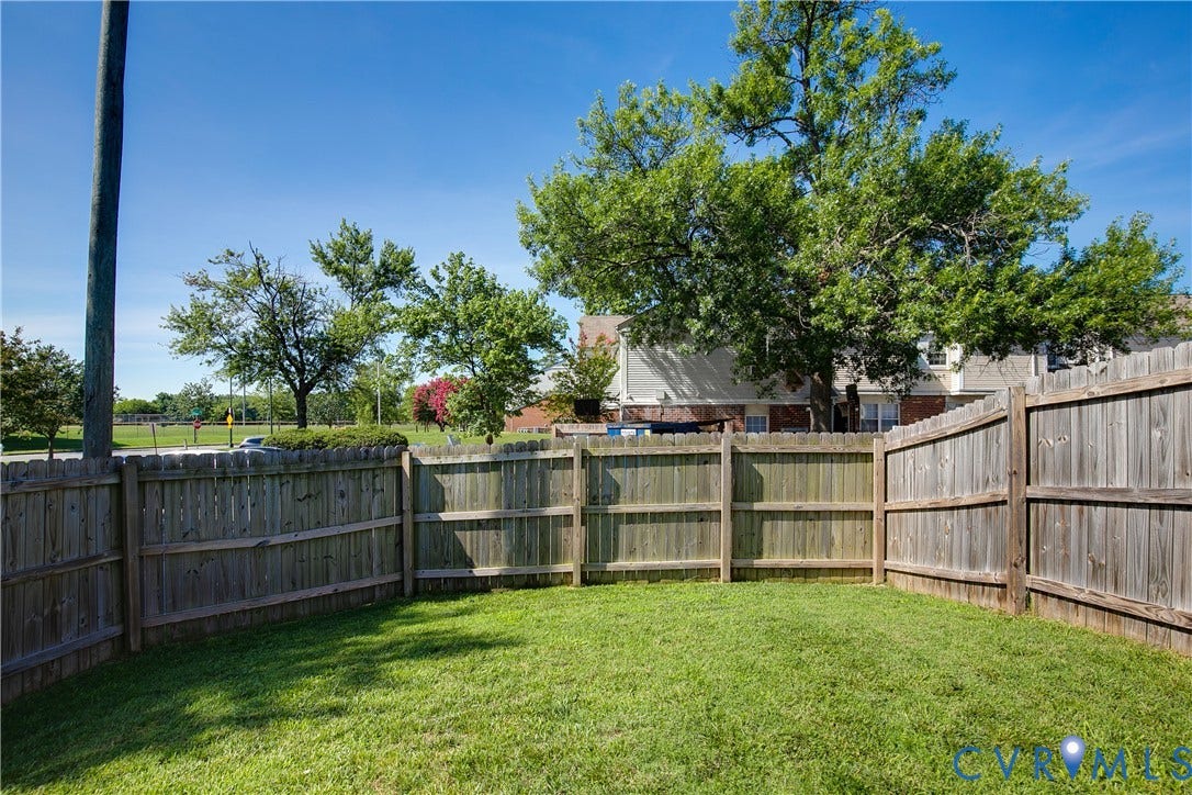 1301 Dance Street, Randolph, Richmond, VA 23220 Expansive backyard featuring a manicured lawn, a full wood privacy fence, and mature trees